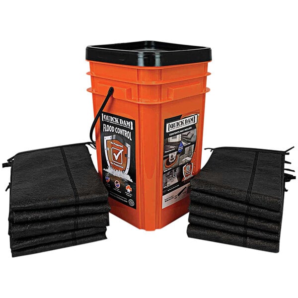 A large orange bucket with a stack of black Quick Dam flood barriers next to it.