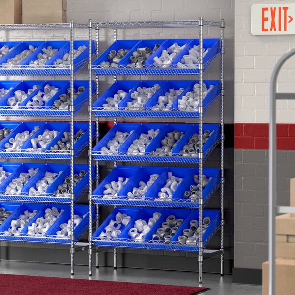 A Regency stationary chrome shelving unit with blue bins on slanted shelves.
