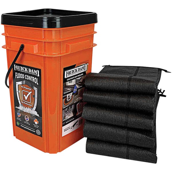 A black bucket with four black bags inside.