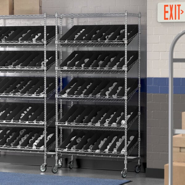 A Regency metal slanted shelf unit with black bins on it.