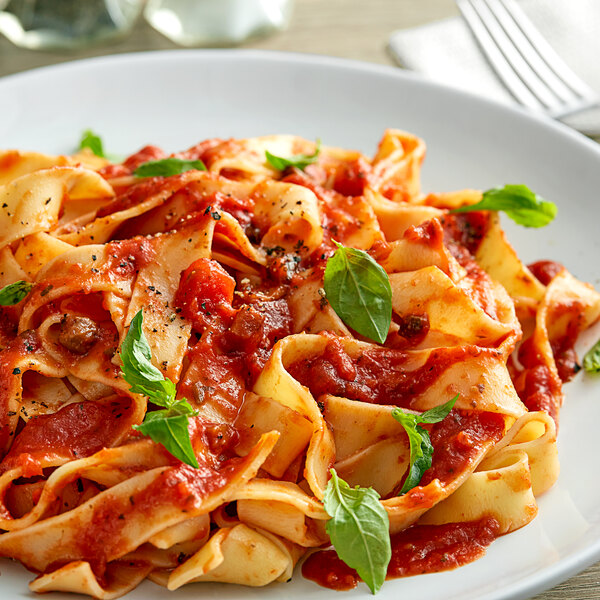 A plate of pasta with Prego Italian Sauce with Fresh Mushrooms and basil.