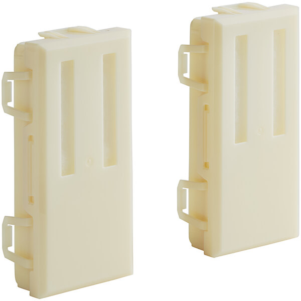 A close-up of two white plastic HEPA filters for a Dyson Airblade V hand dryer.