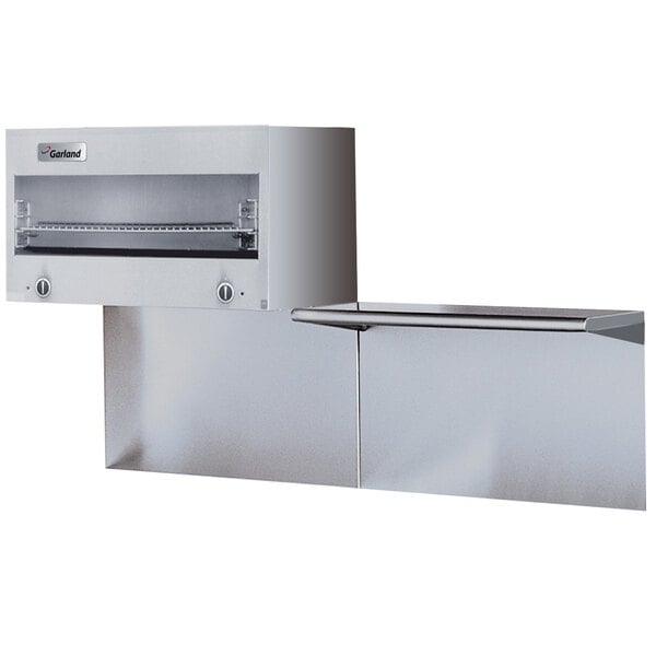 A stainless steel Garland cheese melter with a shelf.
