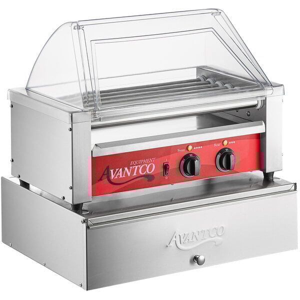 An Avantco commercial hot dog roller grill with a red sneeze guard.