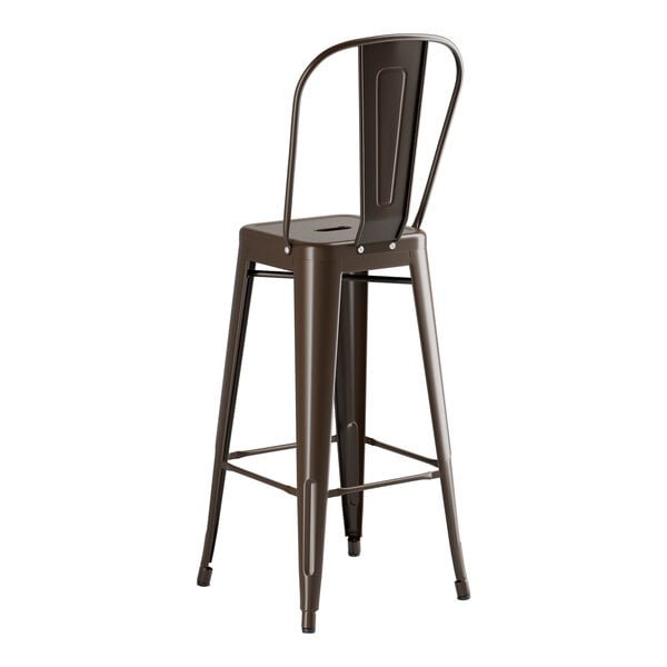 A brown metal bar stool with a backrest at a round copper table.