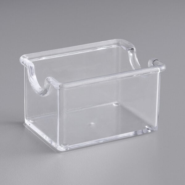 A clear plastic square sugar caddy.
