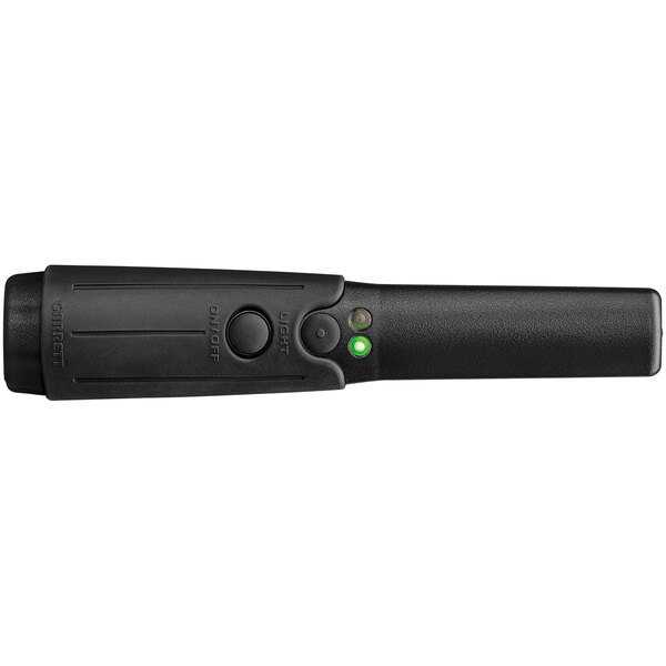 A close up of a black Garrett THD Tactical Handheld Metal Detector with green lights.