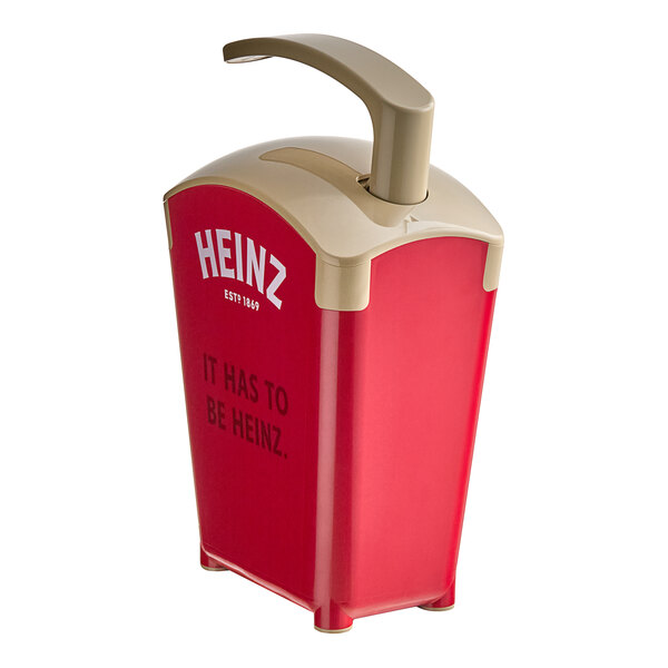 A red and beige plastic Heinz Ketchup dispenser with a tube.