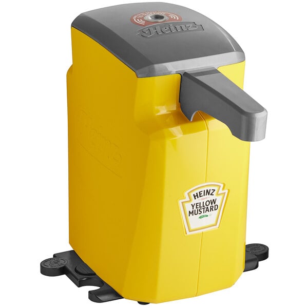 A yellow and grey Heinz countertop mustard pump dispenser with a lid.