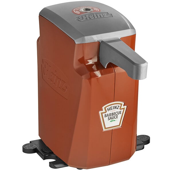 A brown and silver Heinz Keystone countertop pump dispenser with touchless automatic lid.