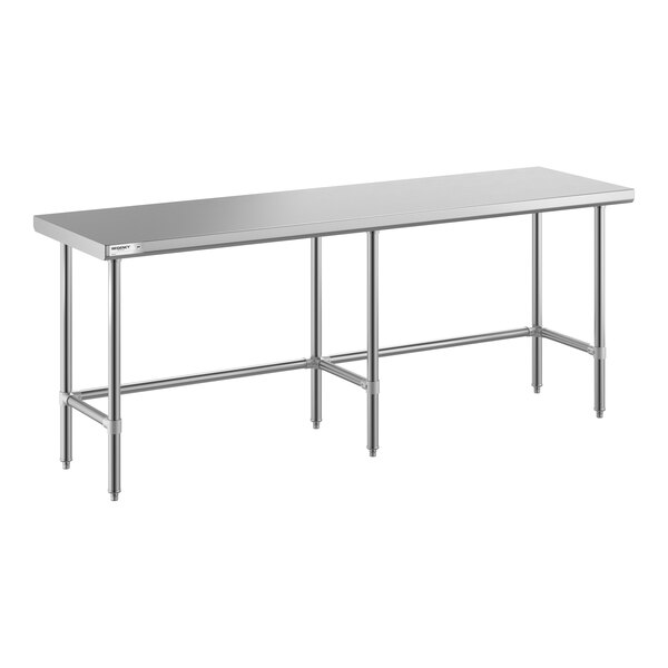 A long, rectangular stainless steel table with an open base and six legs.