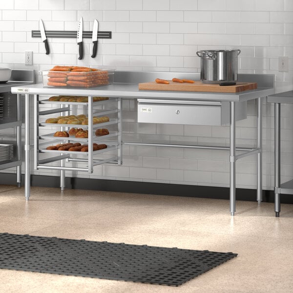 A Regency stainless steel open base work table in a commercial kitchen.