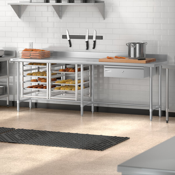 A Regency stainless steel open base work table on a counter in a kitchen.