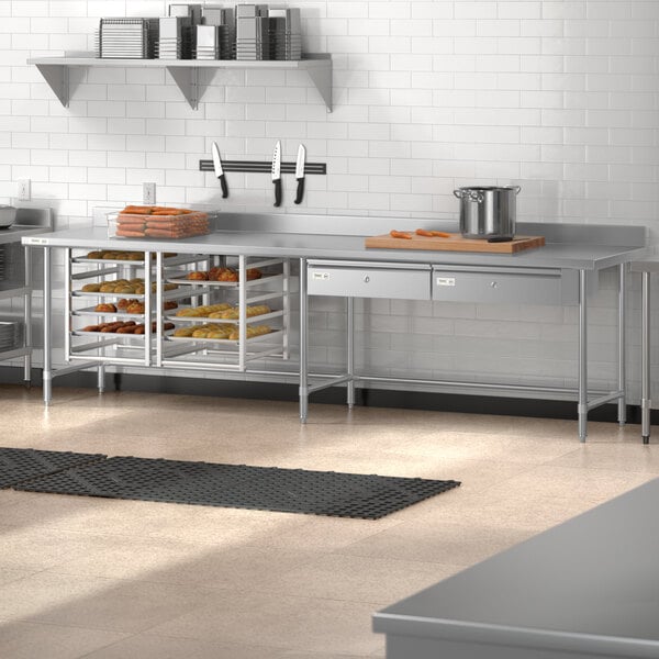 A stainless steel Regency open base work table with a backsplash in a kitchen.