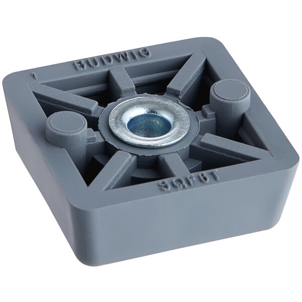 A grey square block with a metal center and nut.