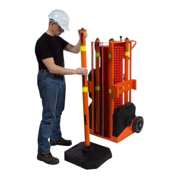 A man using an orange Ideal Warehouse safety barrier pole.