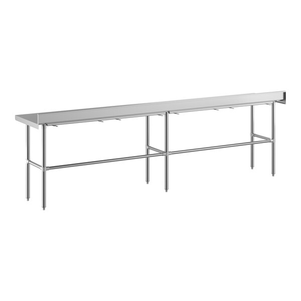 A long, rectangular stainless steel table with an open base, four legs, and a 4-inch backsplash along the back edge.