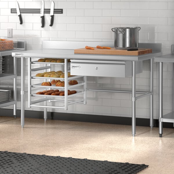 A Regency stainless steel open base work table in a kitchen.