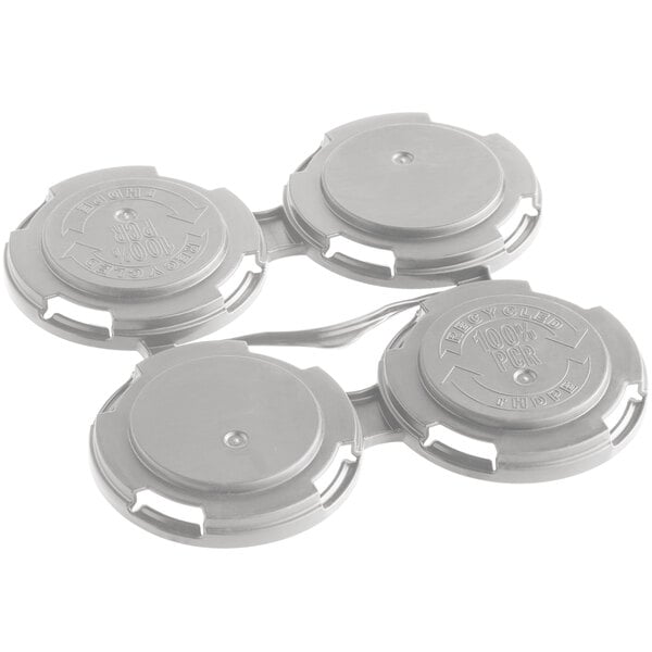 A close-up of a silver PakTech plastic 4-pack carrier with three open circular lids.