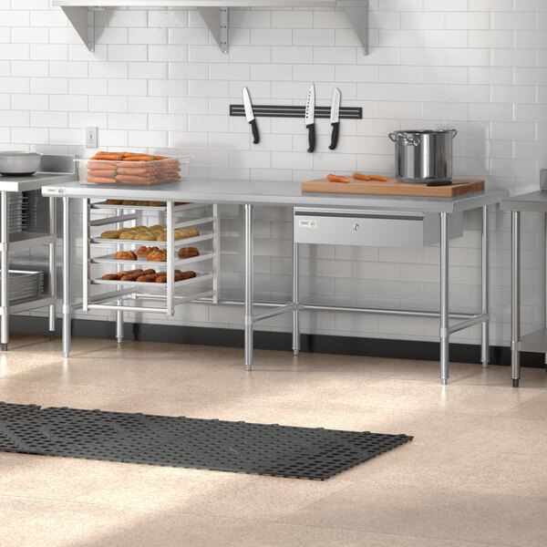 A Regency stainless steel open base work table in a kitchen with shelves.