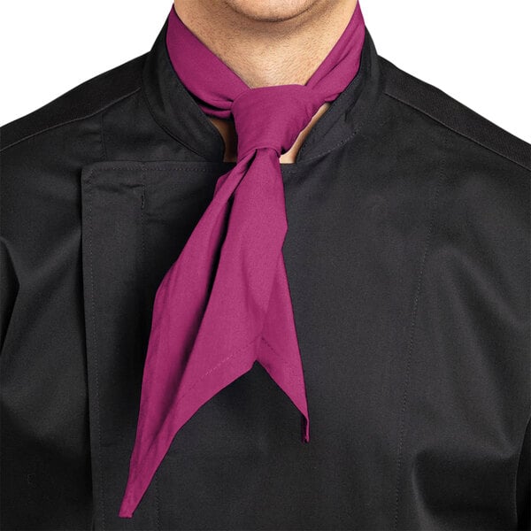 A man wearing a Berry Uncommon Chef neckerchief around his neck in a professional kitchen.