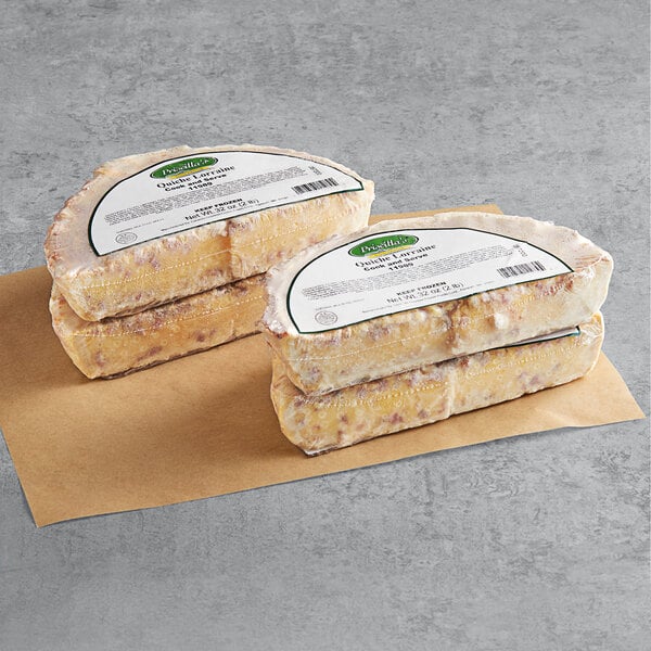 Priscilla's Lorraine quiches stacked on a brown surface.