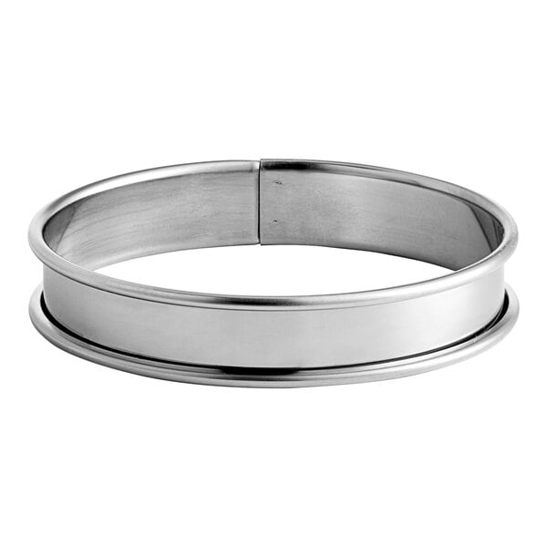 A close-up of a stainless steel Gobel tart ring with a circular design.