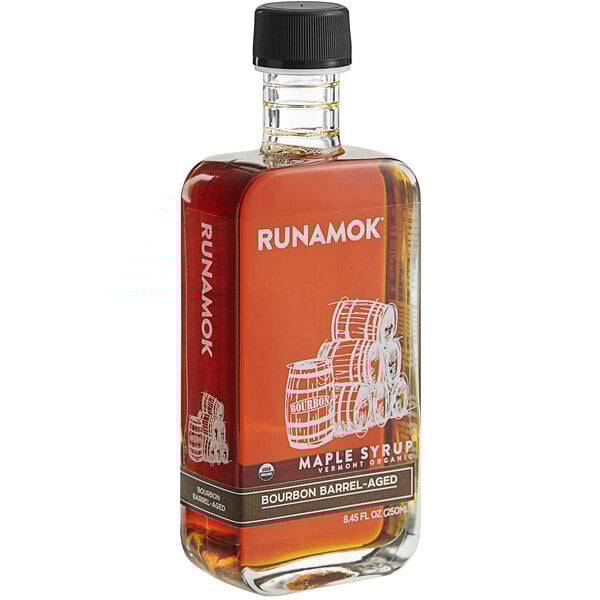 A bottle of Runamok Bourbon Barrel-Aged Maple Syrup with white text on the label.