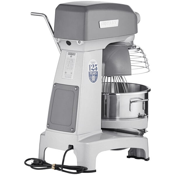 A white Hobart Legacy+ commercial stand mixer with a bowl on it.
