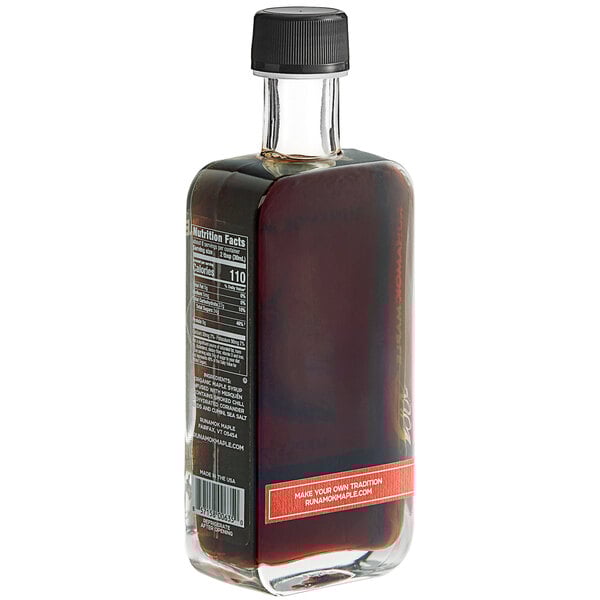A close-up of a bottle of Runamok Merquen Smoked Chili Pepper-Infused Maple Syrup with a label.