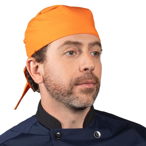 A man wearing an orange carrot print chef bandana.