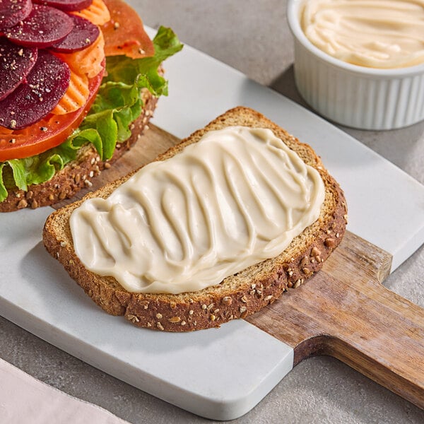 A sandwich with a white spread on it made with Green Oasis Vegan Mayonnaise.