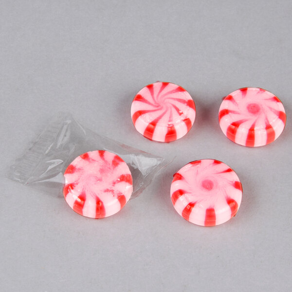 A close up of a red and white Cinnamon Starlite candy.