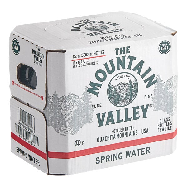 A cardboard box labeled 'The Mountain Valley Spring Water' containing 12 glass bottles of 500 mL each.
