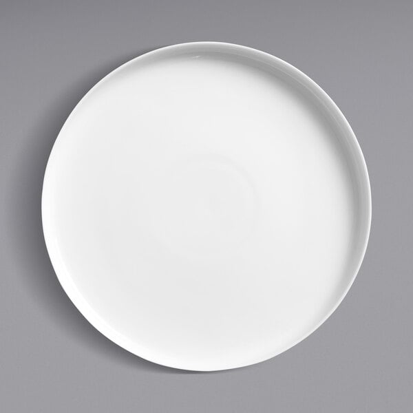 A Oneida Scandi bright white porcelain deep plate with a raised rim on a gray surface.