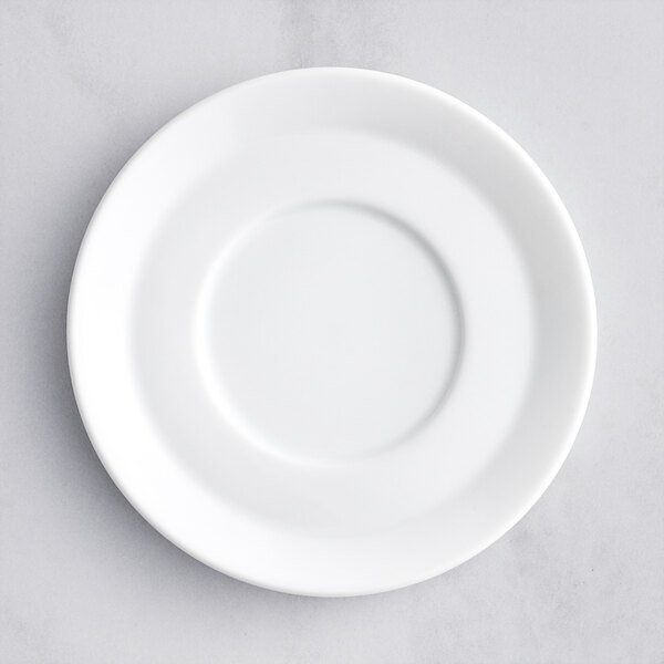 A close-up of a white Oneida Scandi porcelain cappuccino saucer with a white rim.