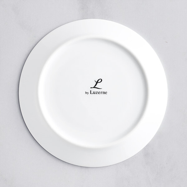 A white Oneida Scandi porcelain saucer with black text that says "le monogram"