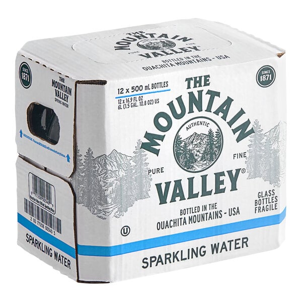 A cardboard box labeled 'The Mountain Valley Sparkling Water' containing 12 glass bottles of 500 mL each.