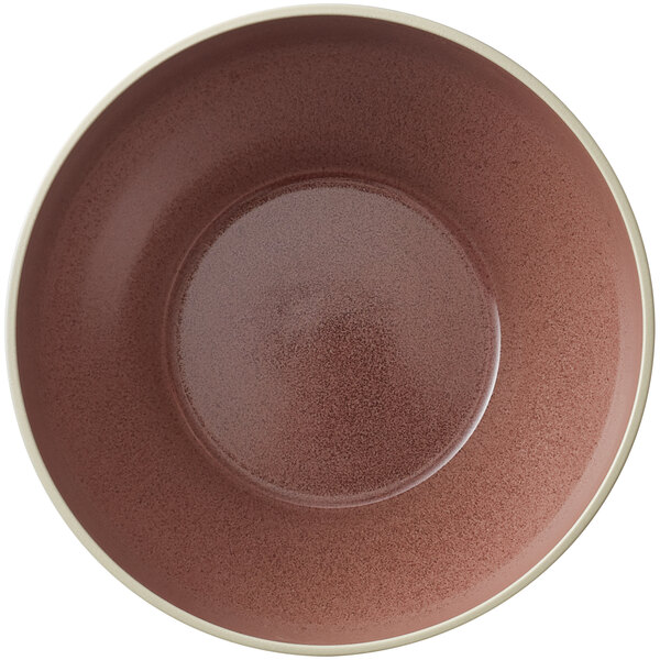 A brown stoneware bowl with a white rim.