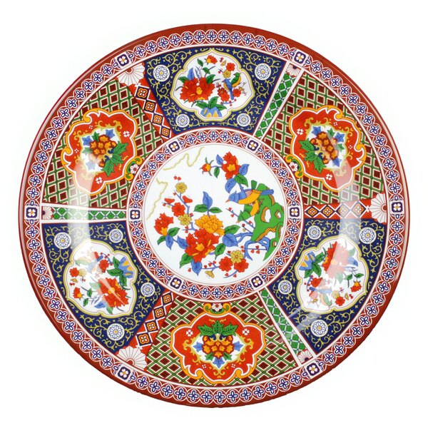 A close-up of a Thunder Group Peacock melamine plate with colorful floral designs.