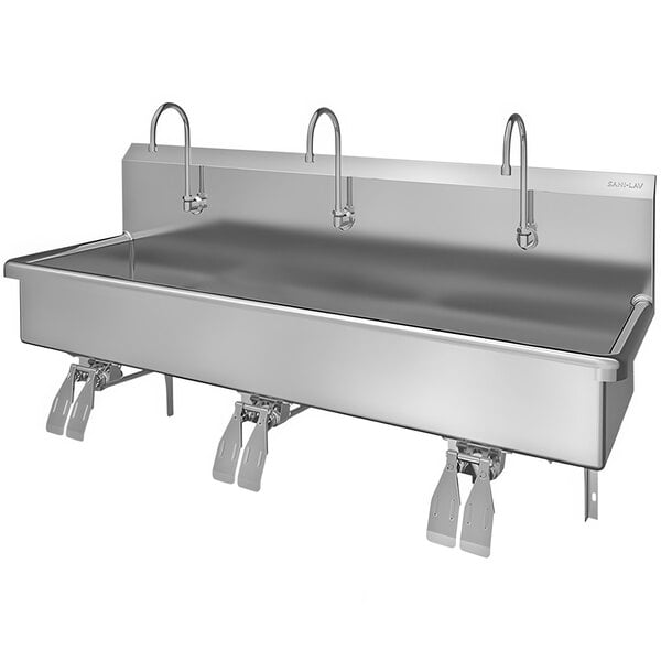 A large stainless steel Sani-Lav wall mounted sink with three knee-operated faucets.