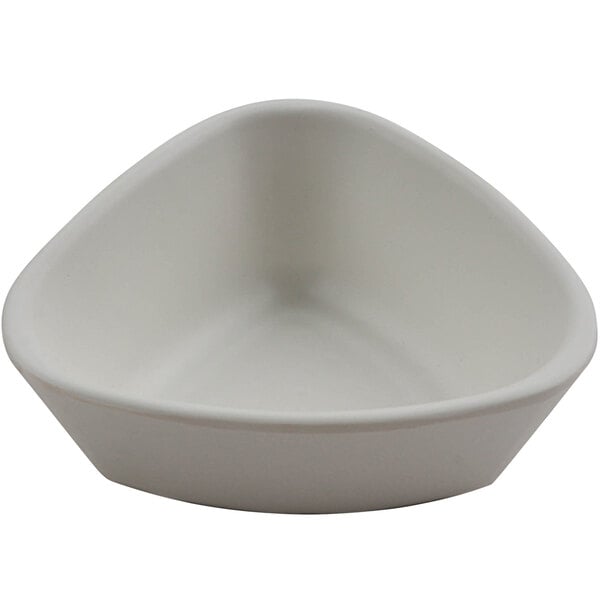 A white cheforward ramekin with a triangle shape.