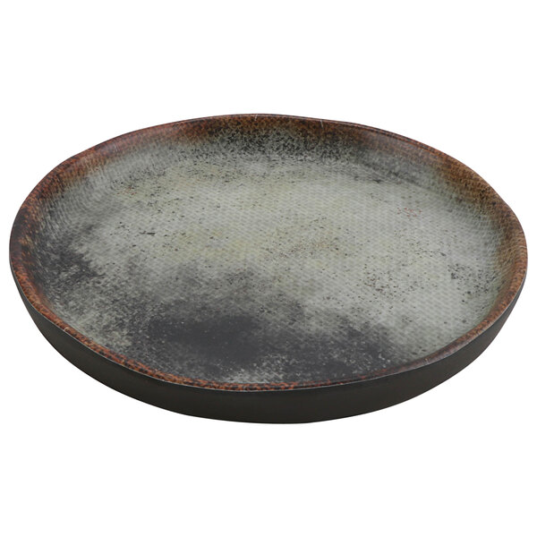 A close up of a cheforward round woven melamine plate with a brown rim.