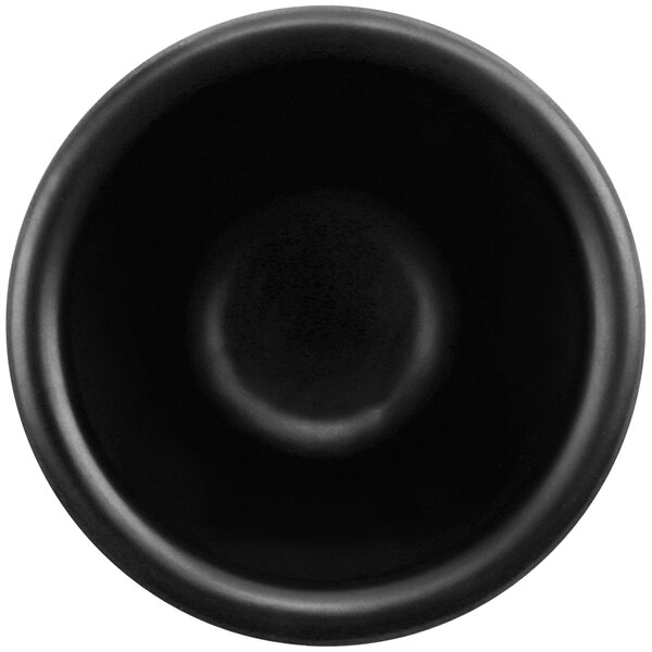 A black cheforward ramekin with a white background.