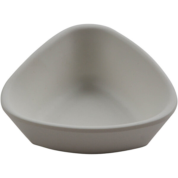 A white cheforward ramekin with a triangle shape on it.