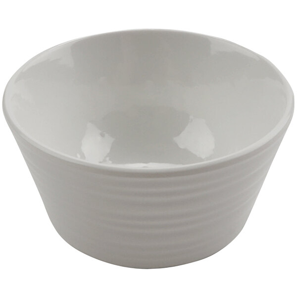 A white cheforward ramekin with a curved edge.