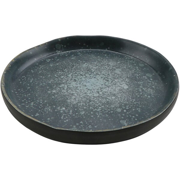 A black round cheforward melamine plate with white specks.