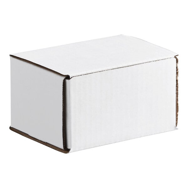 A small white corrugated cardboard mailer box with a tuck top design.