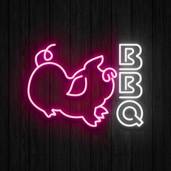 A Canvas Freaks neon sign with the word "BBQ" in pink and white with a pig.