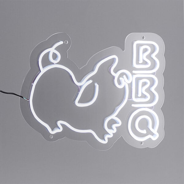 A Canvas Freaks neon sign with the word "BBQ" in white with a pig silhouette.